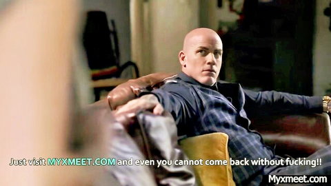 Bald suited man sits confidently in office chair with myxxmeet promo promising hardcore fucking.