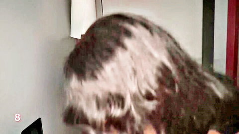 Mature woman with gray hair wearing headset on webcam