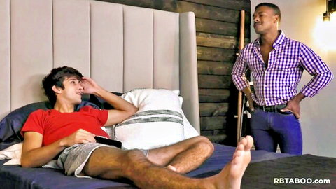Elliot Finn relaxes on bed with ebony stepbrother Adrian Hart standing nearby