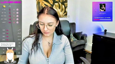 Amateur webcam girl QuinnGreene teases huge tits cleavage in low-cut blue sweater
