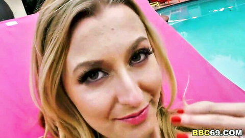 Alexa Grace blonde smiling seductively by pool in pink top