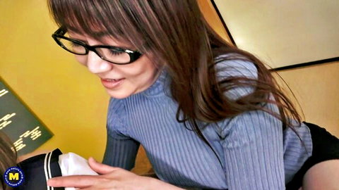 Mature Asian woman in glasses holds panties in teasing pose, lesbian JAV preview
