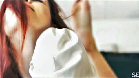 Ecstatic young redhead with long hair moaning sensually mouth open in white off-shoulder top