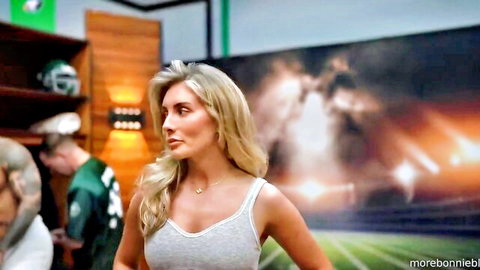 Blonde Bonnie in tight tank top showing cleavage, teasing pose