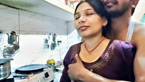 Indian woman with big tits hugged by boyfriend in kitchen, frisky moment