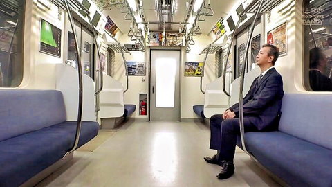 Suited Asian businessman asleep on subway train in JAV setup