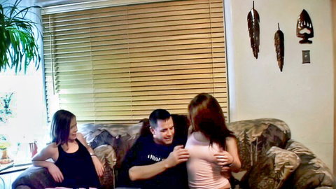 Stepdad with teen brunette and redhead in tank tops, intimate couch pose