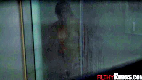 Steamy shower silhouette of nude busty babe with big ass behind foggy glass.