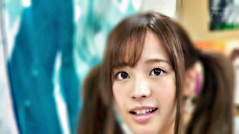 Cute Japanese idol with pigtails smiling in fanservice pose