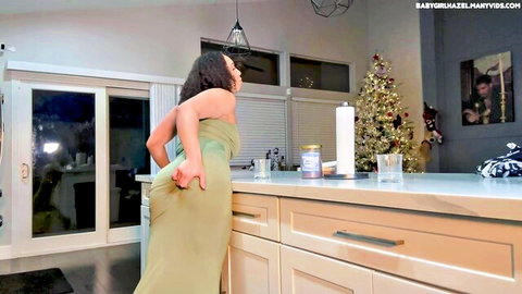 Curvy ebony woman in tight green dress bending over, teasing big ass