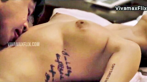 Asian woman with script tattoo topless in intimate kiss scene