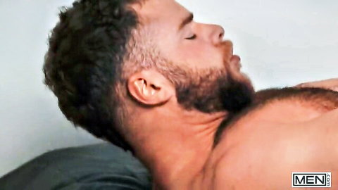 Malik Delgaty lying relaxed, bearded and muscular after threesome