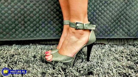 Sporting Terry's naughty MILF feet in sexy green snakeskin high heels