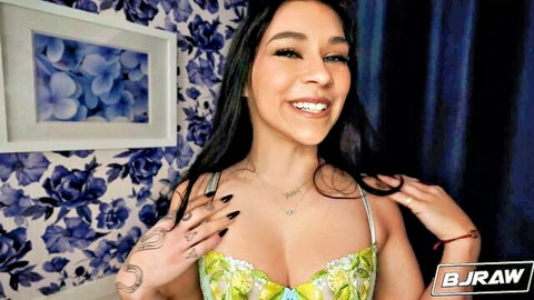 Delilah Dagger smiling in green lace lingerie, teasing cleavage