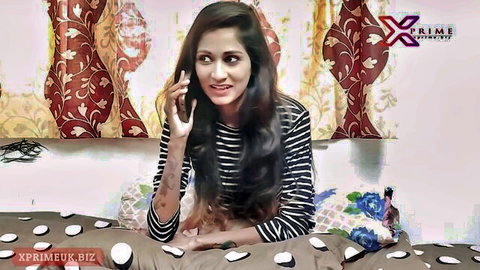 Smiling Indian teen girl in striped top on phone, teasing desi vibe