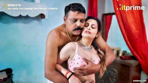 Indian busty woman in pink bra embraced by muscular man