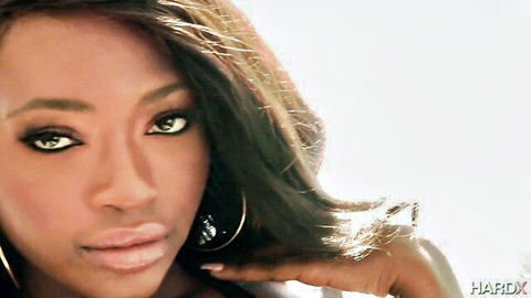 Stunning ebony beauty with sultry eyes and glossy lips in seductive closeup