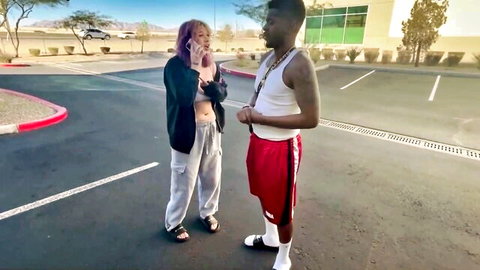 Topless pink-haired white girl flashes huge tits at tattooed BBC black stud in public parking lot