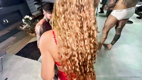 Curly blonde babe in red bra teases big ass surrounded by tattooed white and black studs in bulging Calvin Klein briefs