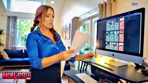 Redhead MILF Rachel Steele in tight blue blouse showing deep cleavage and big tits
