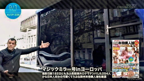 Mustached man in black jacket gestures hand out near open car door with sexy JAV posters in public spot