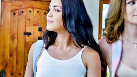 Two nubile young women in tank tops posing seductively
