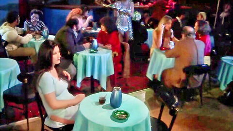 Diverse clothed group dining in retro restaurant with green tables and drinks