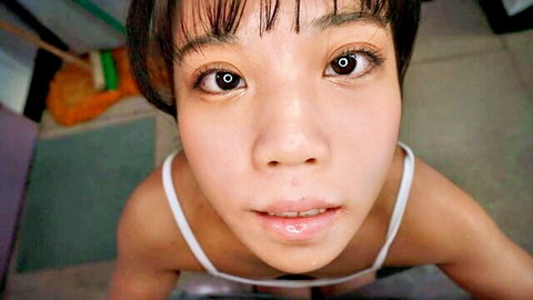 Close-up of Asian woman in white bralette, short hair, aroused expression from nipple play