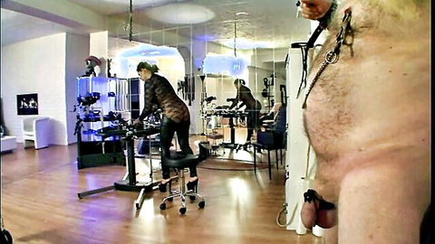 Cruel Femdom: Dominatrix with collared naked male submissive