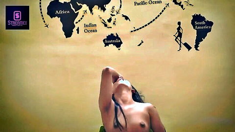 Topless South Asian beauty with perky tits exposed leaning back against world map wall