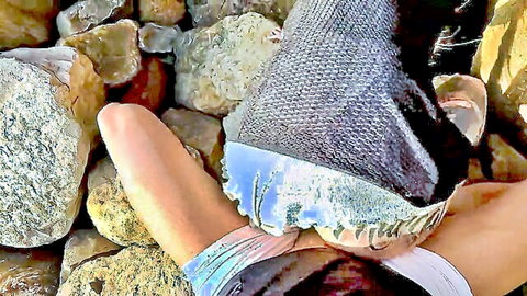 Woman's shaved pussy and bare ass spread wide on rocky beach outdoors