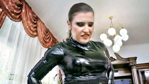 Jessika Girl in tight black latex dominatrix outfit, intense BDSM stare