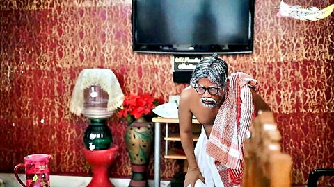 Shirtless hairy elderly Indian man in dhoti bending over wooden bed in ornate bedroom