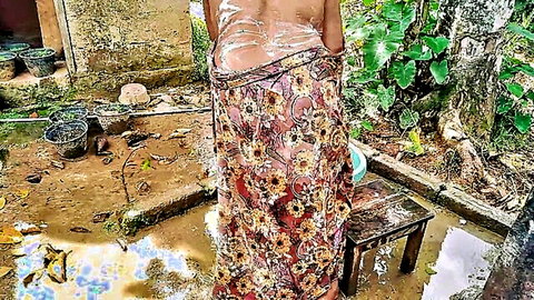 Mature Indian wife topless from behind in skimpy floral sarong outdoors teasing