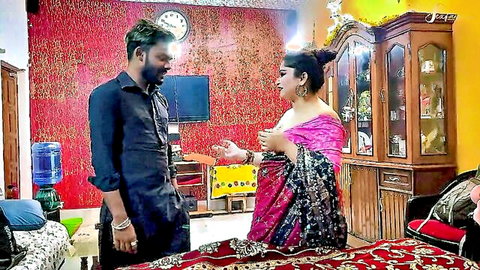 Young Indian man chats with busty mature woman in low-cut pink saree