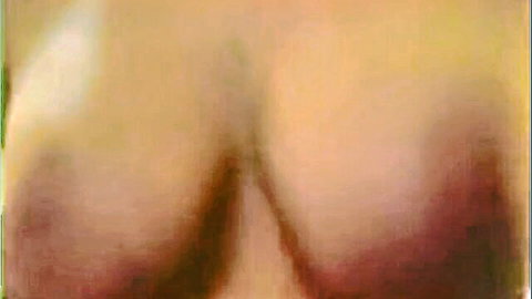 Close-up of busty MILF's massive natural tits with visible nipples and deep cleavage