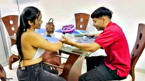Brunette teen in skimpy crop top exposing underboob flirts with boyfriend at glass table