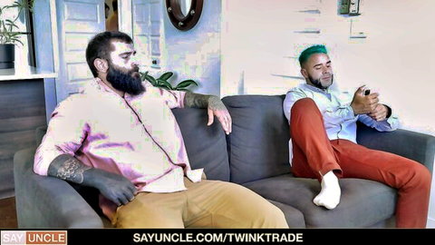 Bearded tattooed guy and green-haired twink lounge on couch in Easter Egg Swap by Twink Trade