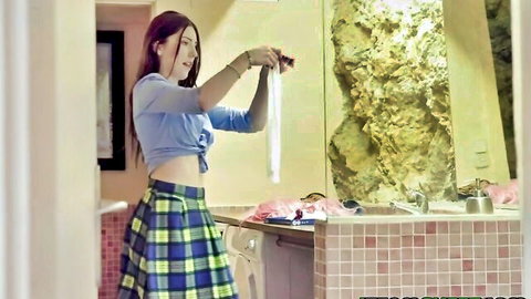 Mia Evans in crop top and plaid skirt holding white panties tease