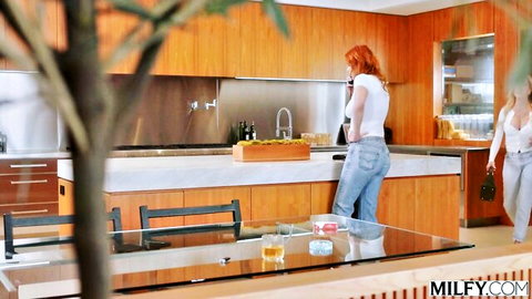 Redhead MILF on phone in white top and jeans with blonde friend in casual outfit