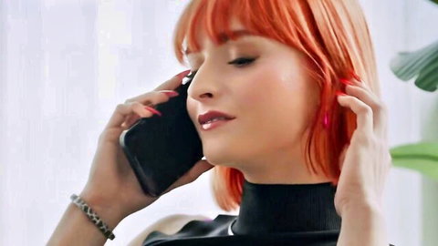 Dolly Dyson redhead on phone in sexy black top, alluring gaze