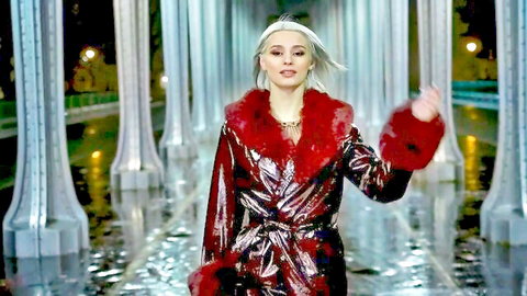 Blonde babe in shiny red fur coat struts seductively at night by water
