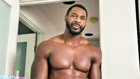 Muscular black bull smirking shirtless in doorway showing ripped abs and chest