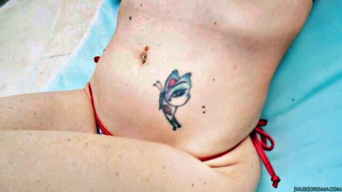 Slim topless teen in red thong bikini by pool with butterfly tattoo