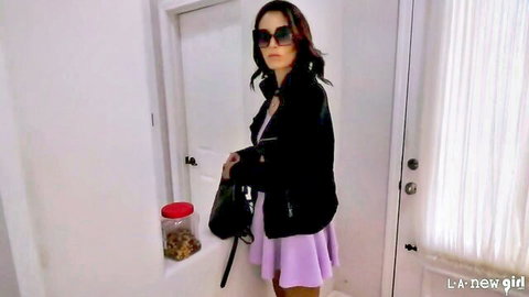 Ari Parker in sexy short pink dress and black leather jacket, teasing pose