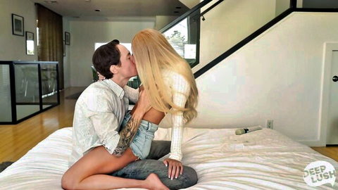 Emma Hix kissing tattooed man passionately on bed in white sweater