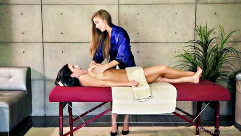 Angela White topless on table as Lena Paul massages her big naturals in lesbian scene