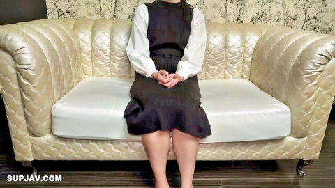Slim tall Asian beauty in black dress, fair skin, seductive sitting pose