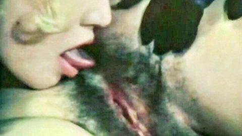 Lesbian babe licks hairy wet pussy with tongue on pink slit closeup