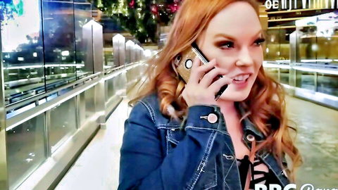 Summer Hart on phone call, smiling redhead in denim jacket